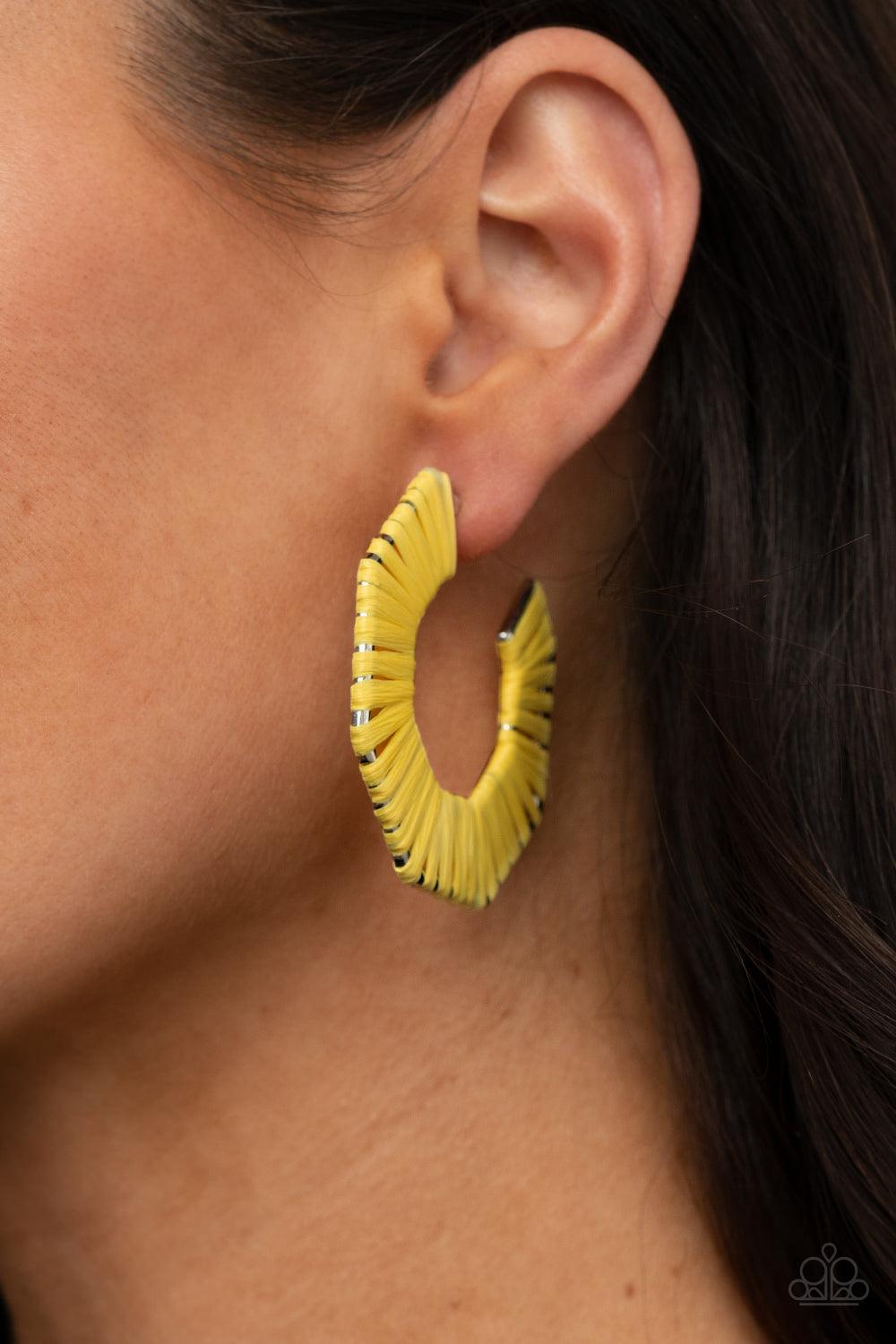 Paparazzi Accessories Fabulously Fiesta - Yellow Illuminating wicker-like cording is wrapped around a hexagonal hoop, creating a colorful pop of color. Earring attaches to a standard post fitting. Hoop measures approximately 2" in diameter. Sold as one pa