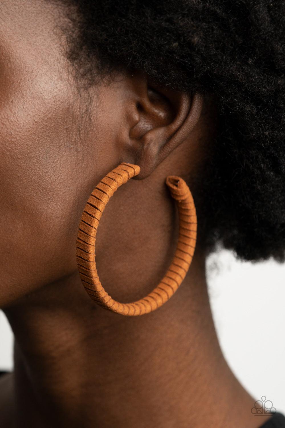 Paparazzi Accessories Suede Parade - Brown Tan suede cording wraps around an oversized hoop, creating an earthy pop of color. Earring attaches to a standard post fitting. Hoop measures approximately 2 1/4" in diameter. Sold as one pair of hoop earrings. J