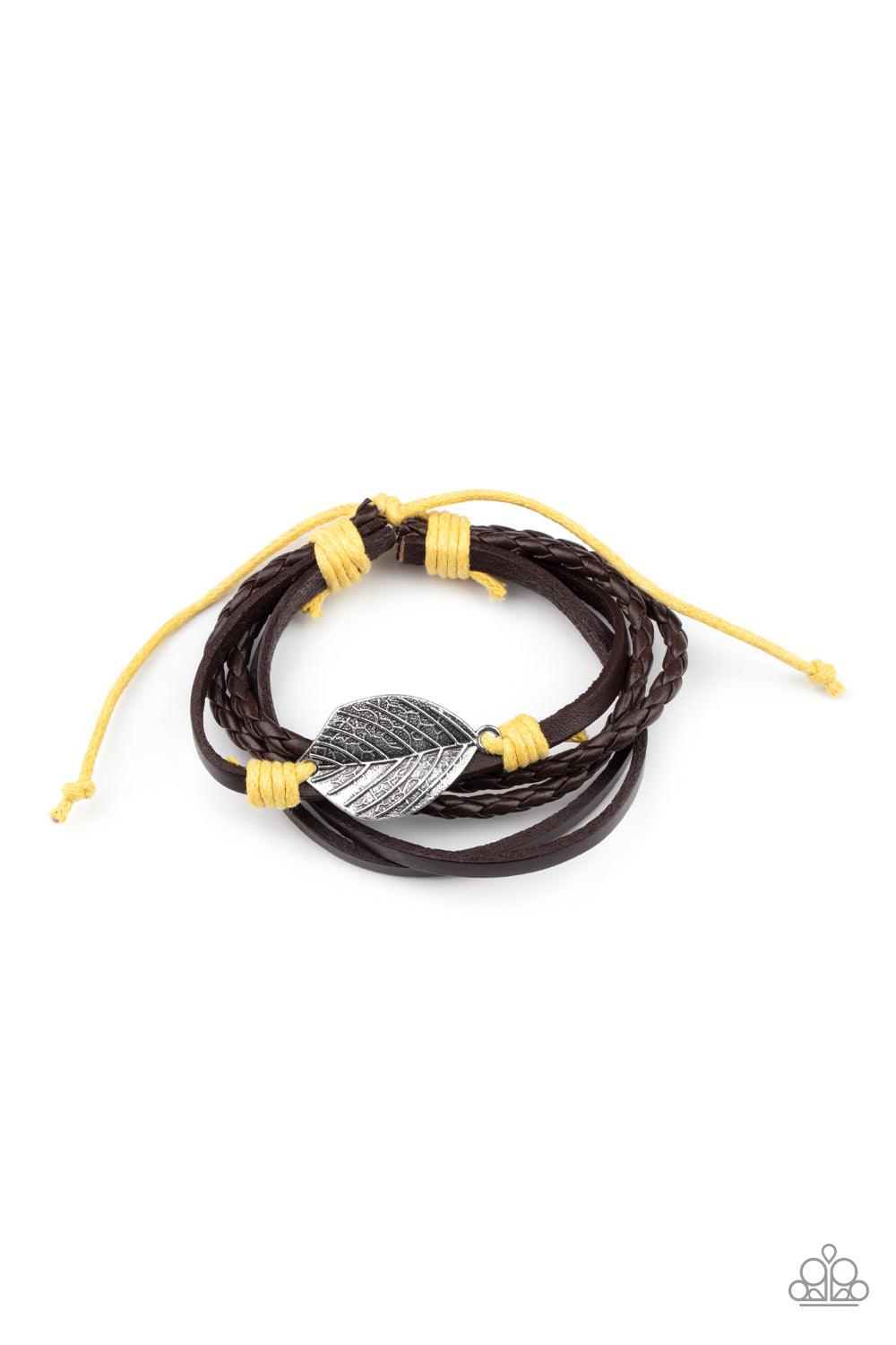 Paparazzi Accessories FROND and Center - Yellow A lifelike silver leaf frame is knotted in place with yellow cording across the front of a dainty brown leather band. Matching plain and braided leather bands join the centerpiece, creating earthy layers aro