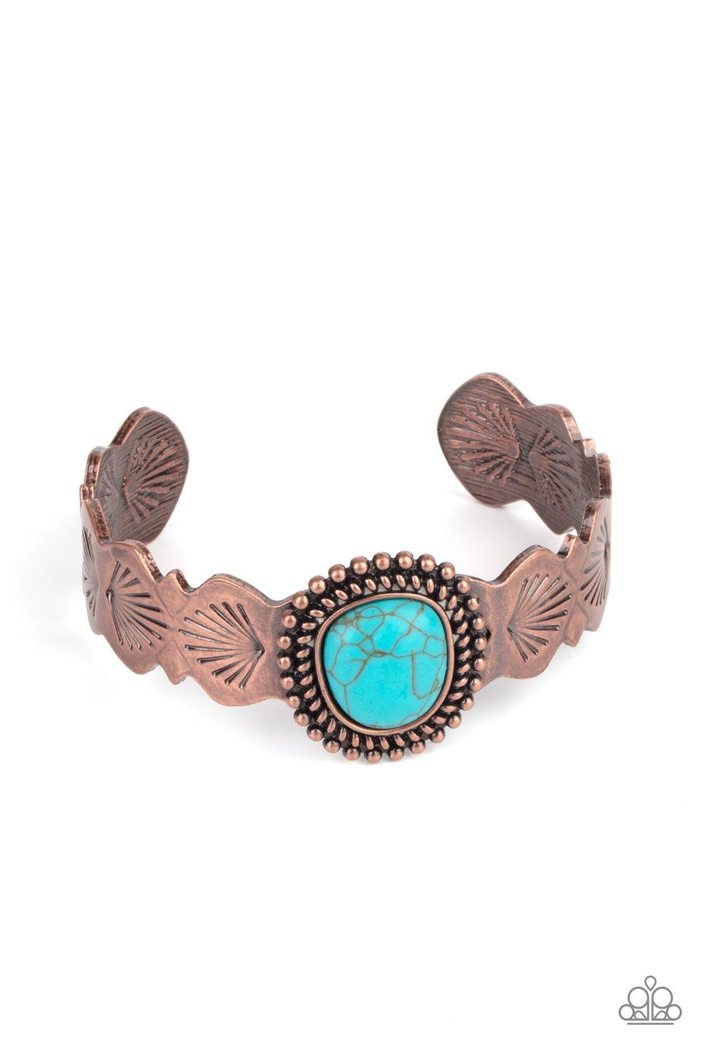 Paparazzi Accessories Oceanic Oracle - Copper An asymmetrical turquoise stone is pressed into the center of an abstract studded copper frame. The earthy stone piece sits off-center atop a scalloped copper cuff stamped in seashell patterns, creating a whim