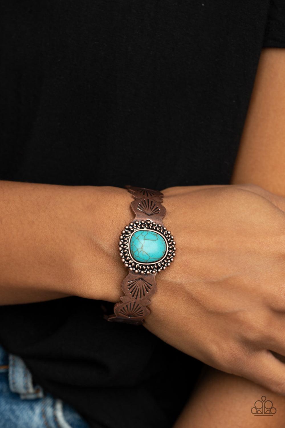 Paparazzi Accessories Oceanic Oracle - Copper An asymmetrical turquoise stone is pressed into the center of an abstract studded copper frame. The earthy stone piece sits off-center atop a scalloped copper cuff stamped in seashell patterns, creating a whim