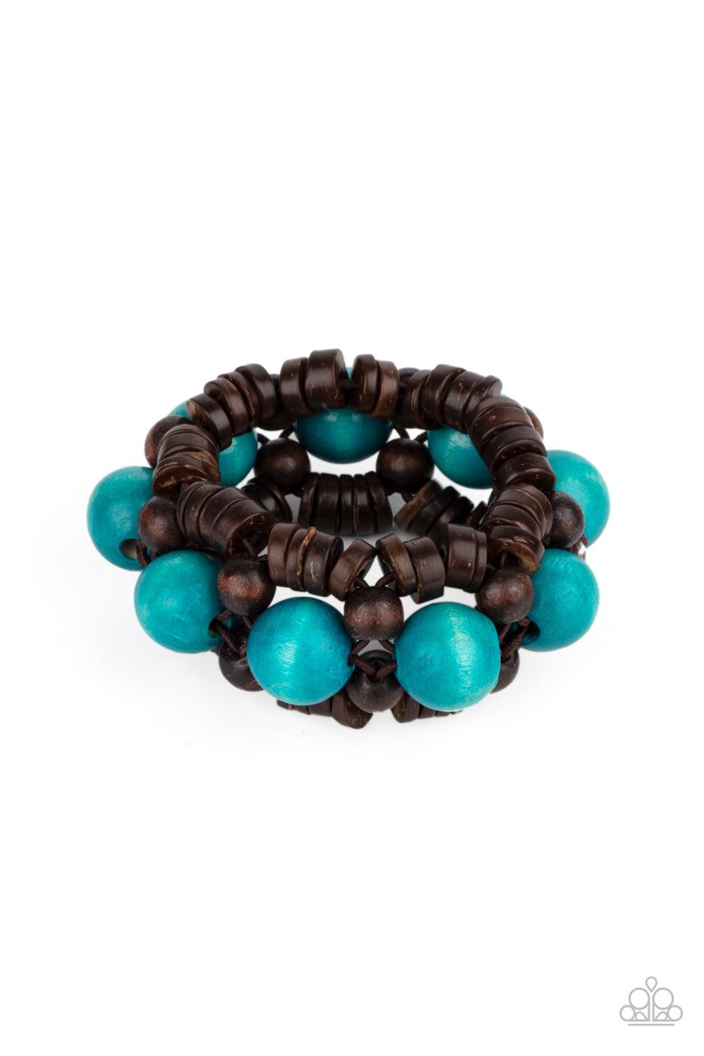 Paparazzi Accessories Tropical Temptations - Blue Oversized blue wooden beads, rustic brown wooden beads, and dainty wooden discs are ornately threaded along braided stretchy bands around the wrist, creating a summery centerpiece. Sold as one individual b