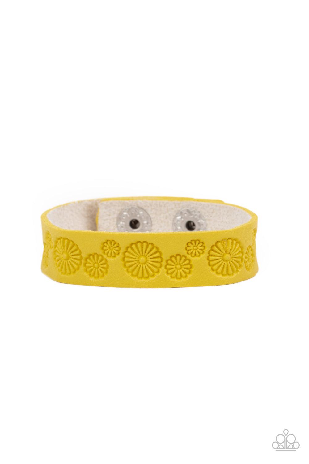 Paparazzi Accessories Follow The Wildflowers - Yellow Stamped in a whimsical daisy pattern, a dainty Illuminating leather band wraps around the wrist for a seasonal flair. Features an adjustable snap closure. Sold as one individual bracelet. Jewelry