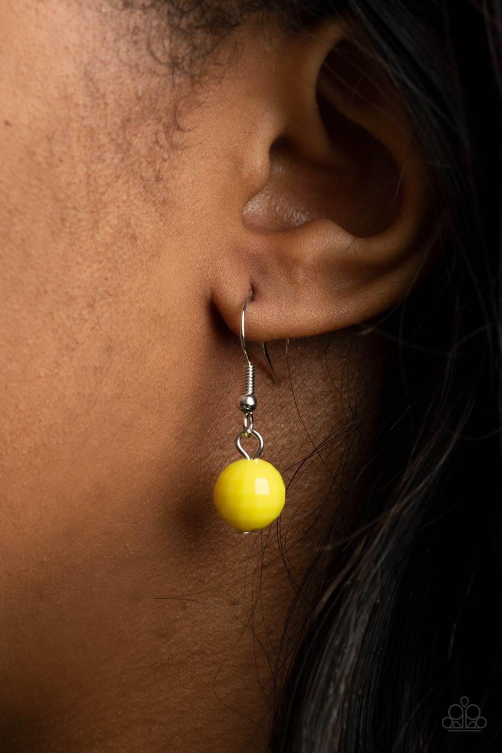 Paparazzi Accessories Resort Ready - Yellow Featuring square facets, strands of shimmery Illuminating beads give way to an oversized collection of flattened Illuminating beads. Featuring faceted surfaces, the asymmetrical beads catch and reflect the light
