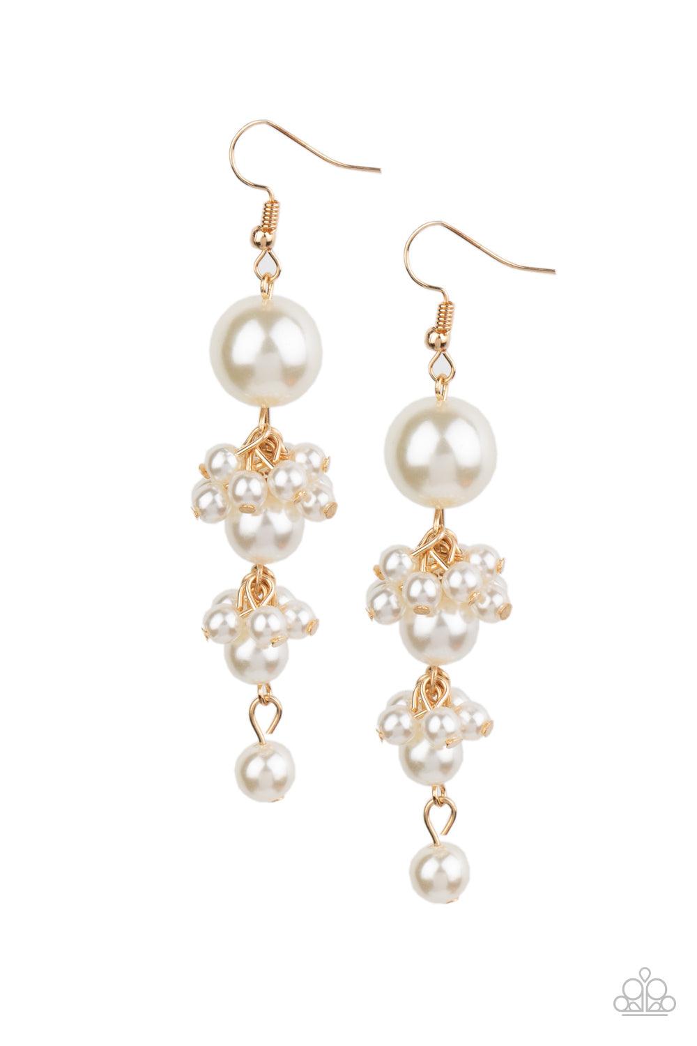 Paparazzi Accessories Ageless Applique - Gold Clusters of dainty white pearls trickle along a glistening gold chain that delicately links together a bubbly strand of pearls. The classic pearls gradually decrease in size, creating a timelessly tasseled dis