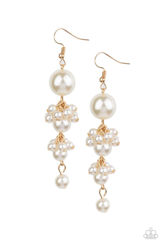 Paparazzi Accessories Ageless Applique - Gold Clusters of dainty white pearls trickle along a glistening gold chain that delicately links together a bubbly strand of pearls. The classic pearls gradually decrease in size, creating a timelessly tasseled dis