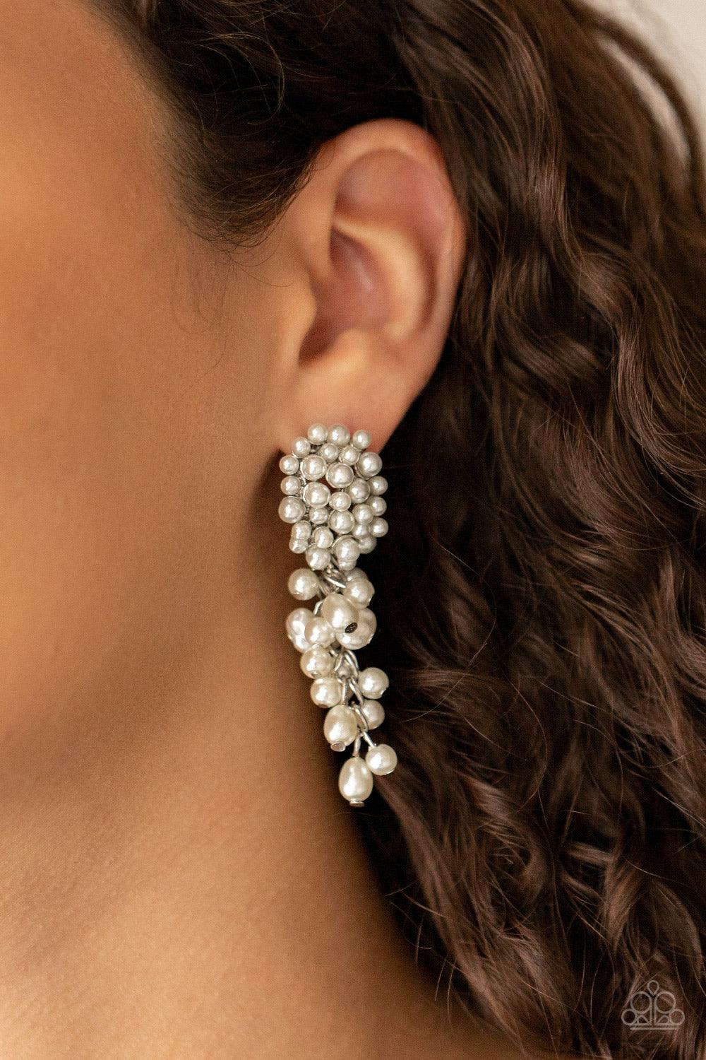 Paparazzi Accessories Fabulously Flattering - White Featuring imperfect finishes, a bubbly tassel of white pearls trickles from the bottom of a pearl encrusted silver fitting for a timeless look. Earring attaches to a standard post fitting. Sold as one pa