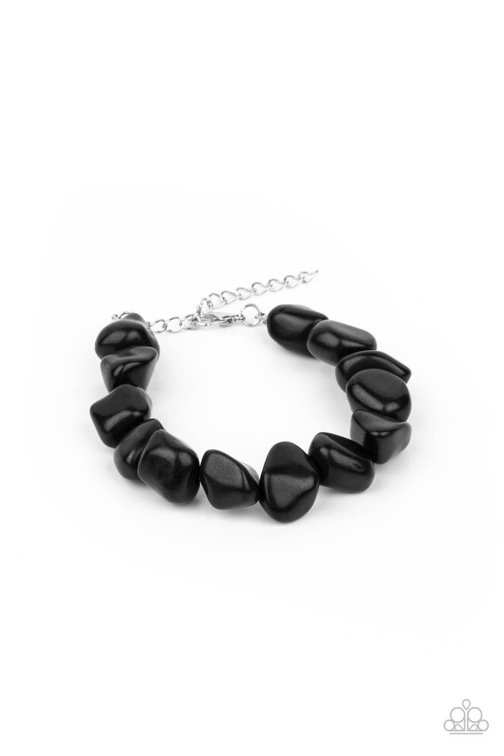 Paparazzi Accessories Prehistoric Paradise - Black A collection of imperfect black stones are threaded along an invisible wire around the wrist, creating an earthy centerpiece. Features an adjustable clasp closure. Sold as one individual bracelet. Bracele