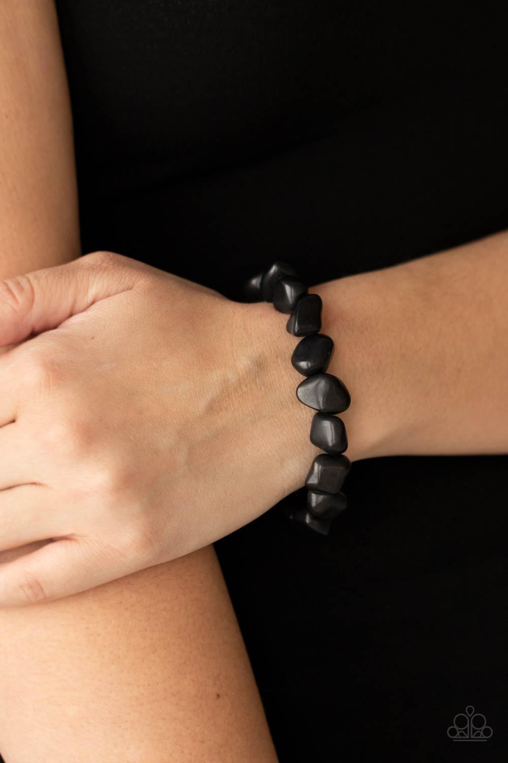 Paparazzi Accessories Prehistoric Paradise - Black A collection of imperfect black stones are threaded along an invisible wire around the wrist, creating an earthy centerpiece. Features an adjustable clasp closure. Sold as one individual bracelet. Bracele
