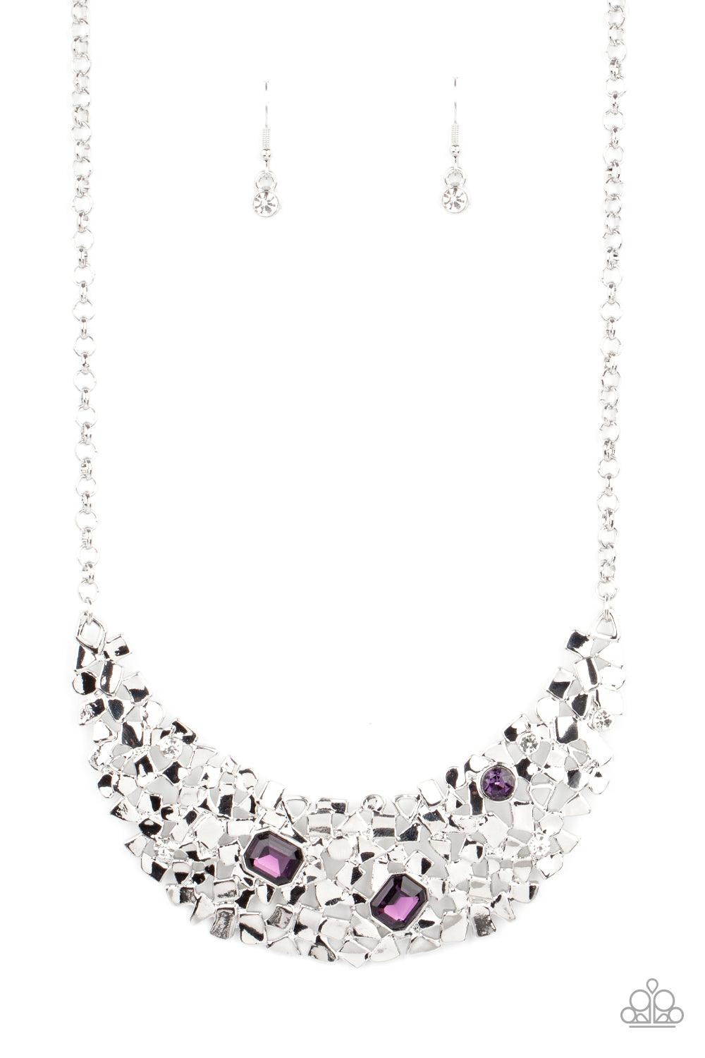 Paparazzi Accessories Fabulously Fragmented - Purple Sporadically dotted in mismatched purple and white rhinestones, a smattering of fragmented silver frames coalesce into a bold half moon below the collar for an edgy fashion. Features an adjustable clasp