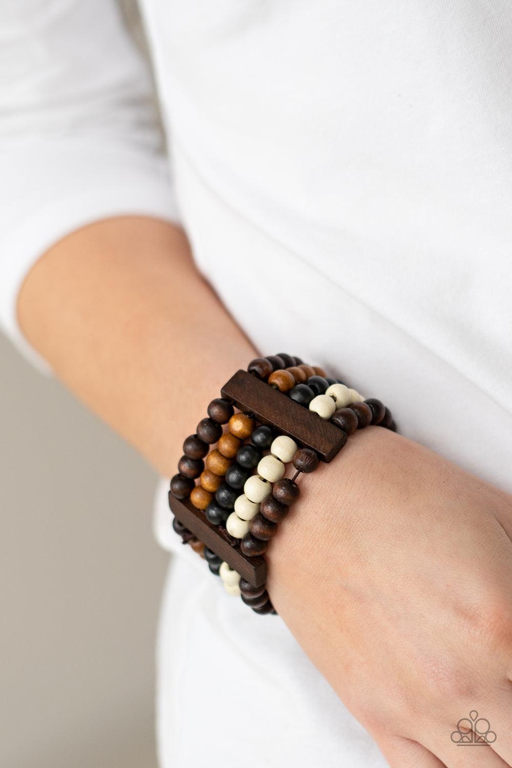 Paparazzi Accessories Caribbean Catwalk - Multi Held in place by rectangular wooden frames, strands of brown, black, and white wooden beads are threaded along stretchy bands around the wrist for a colorfully tropical look. Sold as one individual bracelet.