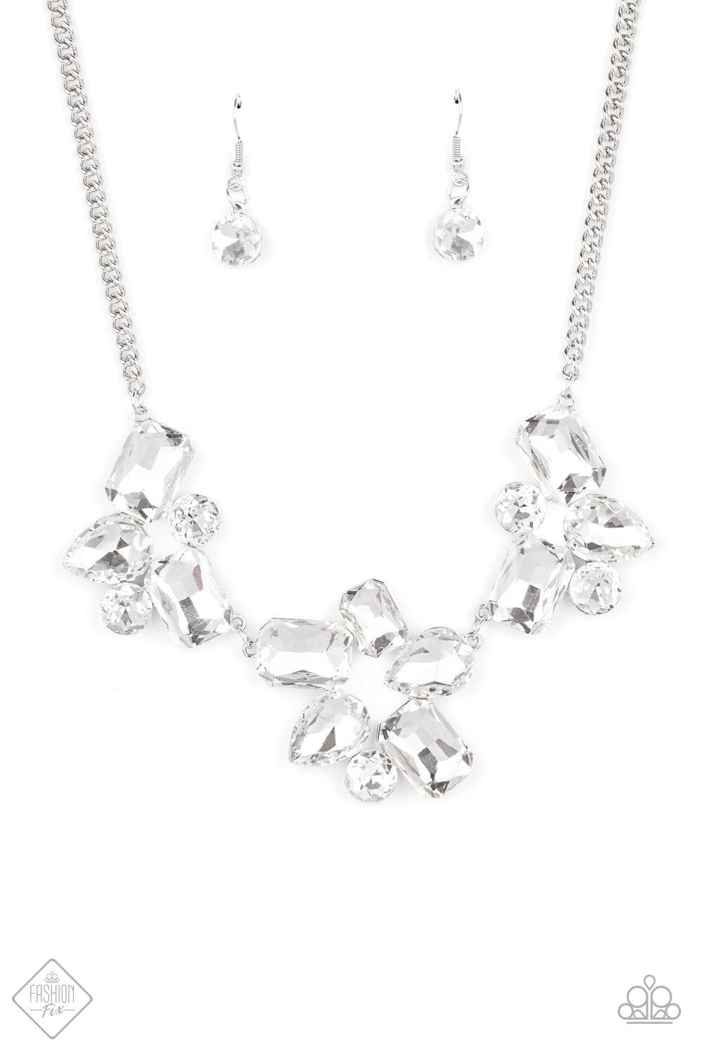 Paparazzi Accessories Galactic Goddess - White An unexpected explosion of oversized round, teardrop, and emerald cut rhinestones cluster into haphazard groupings. The blinding clusters link together, creating a stellar statement piece that sits below the
