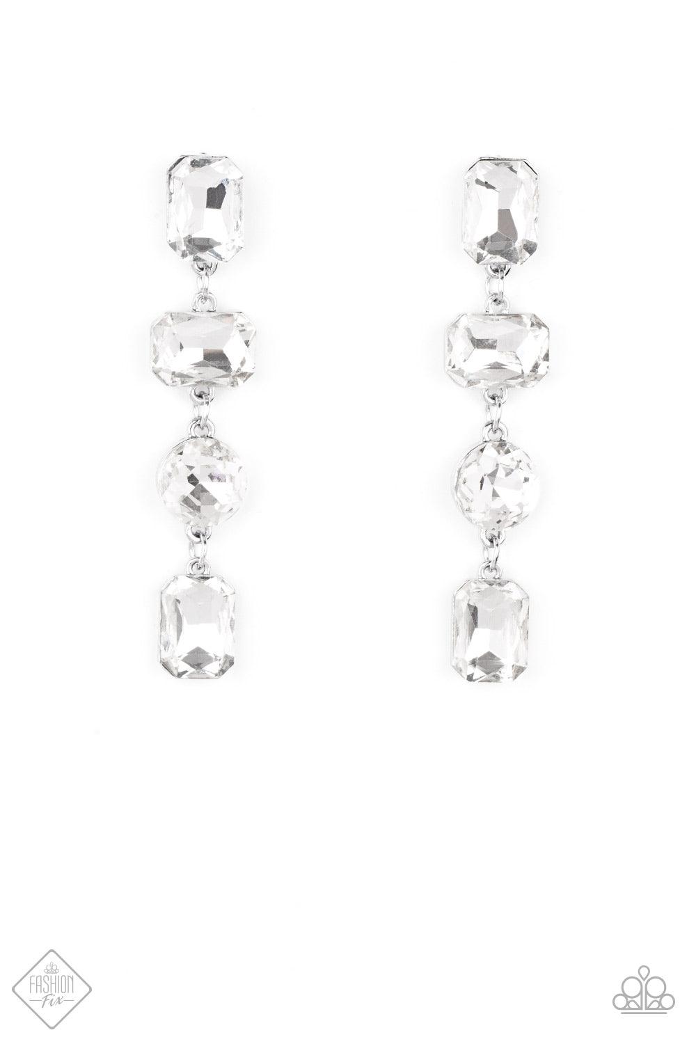 Paparazzi Accessories Cosmic Heiress - White A strand of oversized round, teardrop, and emerald cut rhinestones trickles from the ear, creating a jaw-dropping chandelier. Earring attaches to a standard post earring. Sold as one pair of post earrings. Jewe