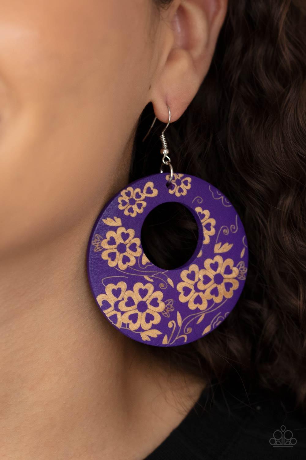 Paparazzi Accessories Galapagos Garden Party - Purple The front of a purple wooden frame is delicately etched in a flowery tropical pattern, creating a colorful hoop. Earring attaches to a standard fishhook fitting. Sold as one pair of earrings. Jewelry