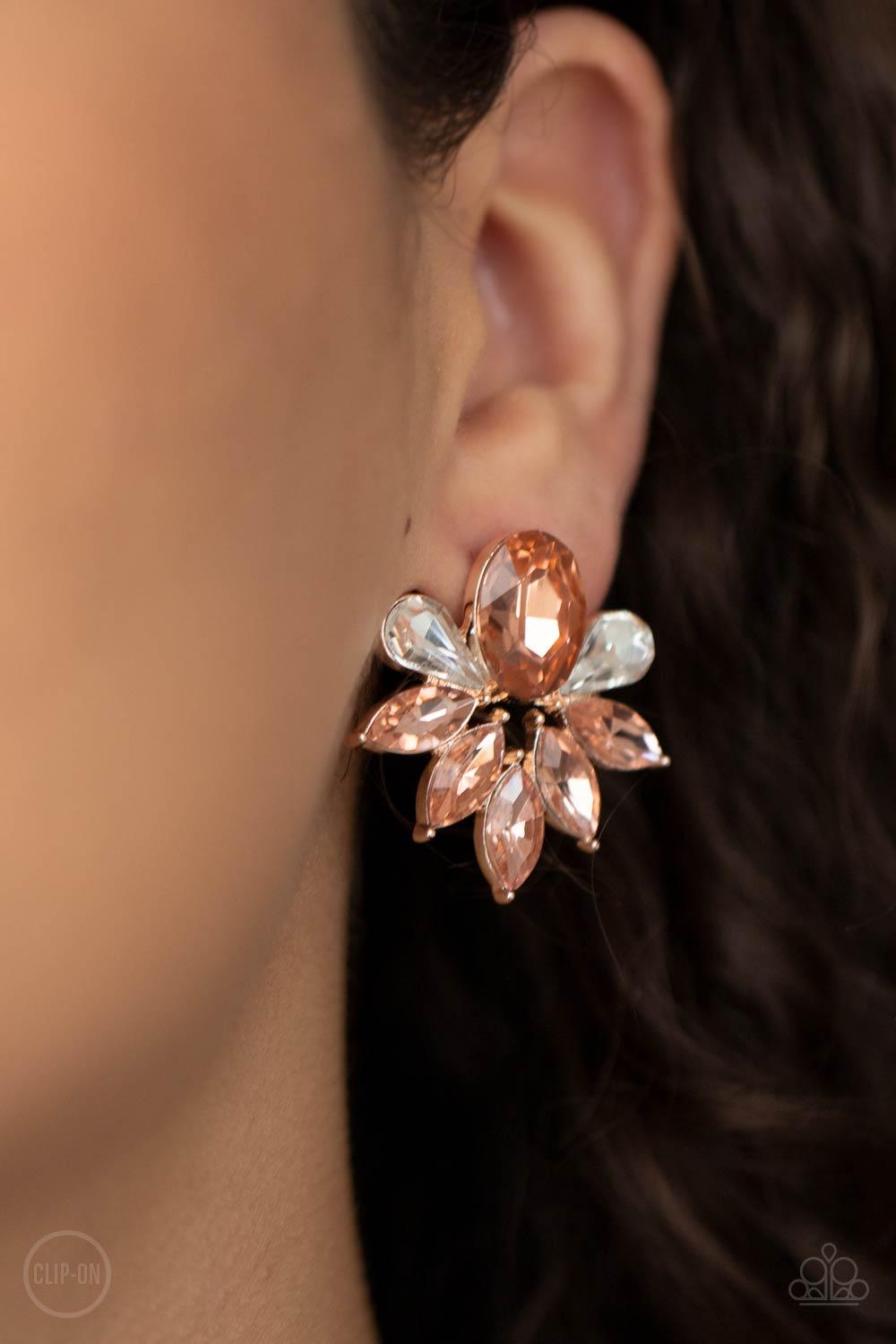 Paparazzi Accessories Fearless Finesse - Rose Gold *Clip-On A glassy collection of white teardrop and rose gold marquise cut rhinestones fan out from the bottom of an oval rose gold gem, creating a majestic centerpiece. Earring attaches to a standard clip