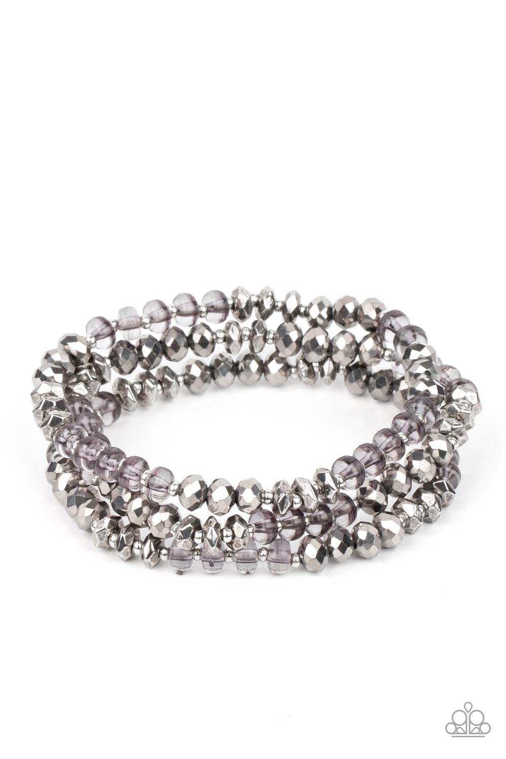 Paparazzi Accessories Stellar Strut - Silver Infused with faceted silver beads, a glamorous collection of sparkly hematite crystals and smoky beads are threaded along stretchy bands around the wrist, creating glittery layers. Sold as one set of three brac