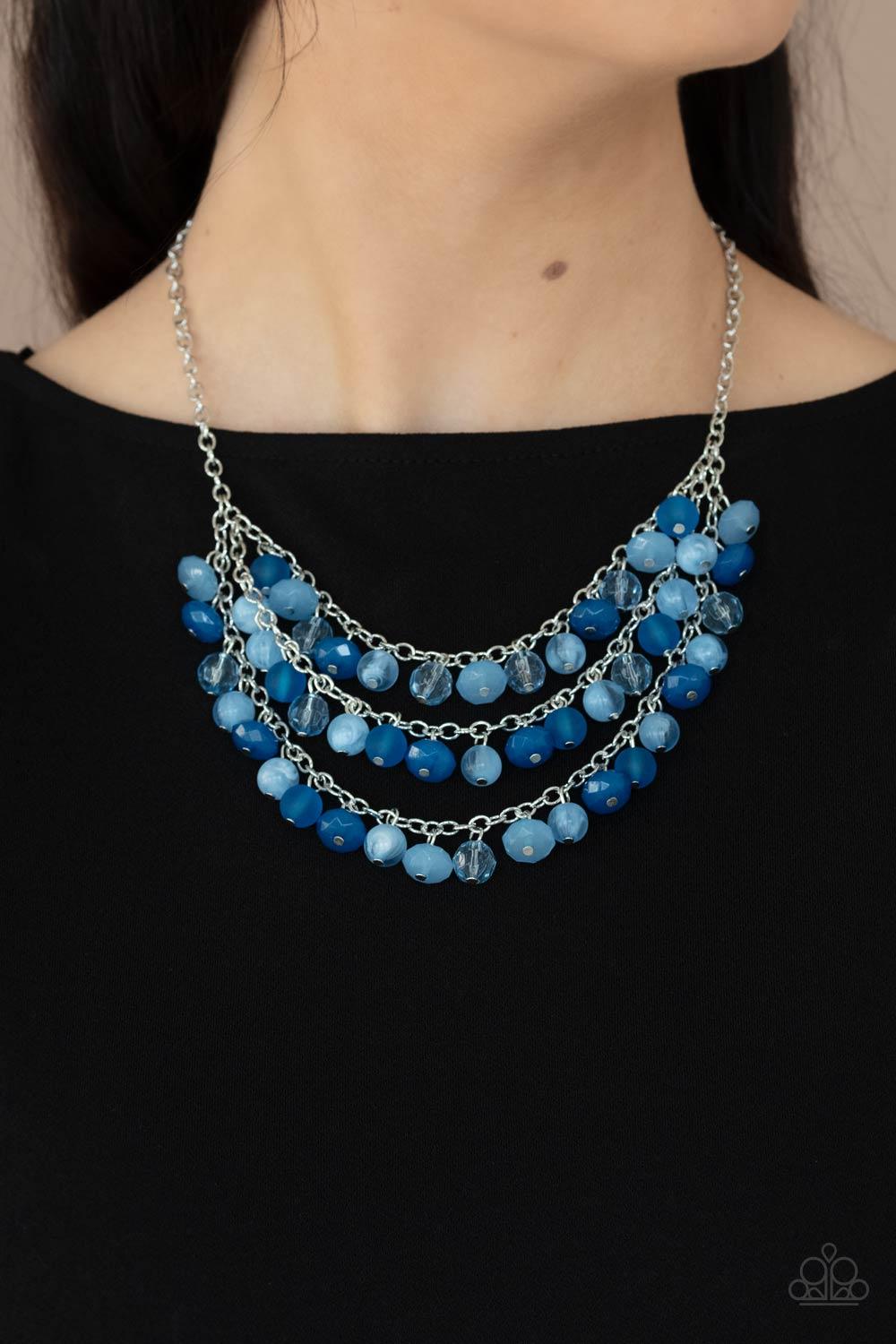 Paparazzi Accessories Fairytale Timelessness - Blue Varying in shape and opacity, a mismatched collection of blue and Cerulean crystal-like beads drip from the shimmery silver chains, creating an enchanted layered fringe below the collar. Features an adju