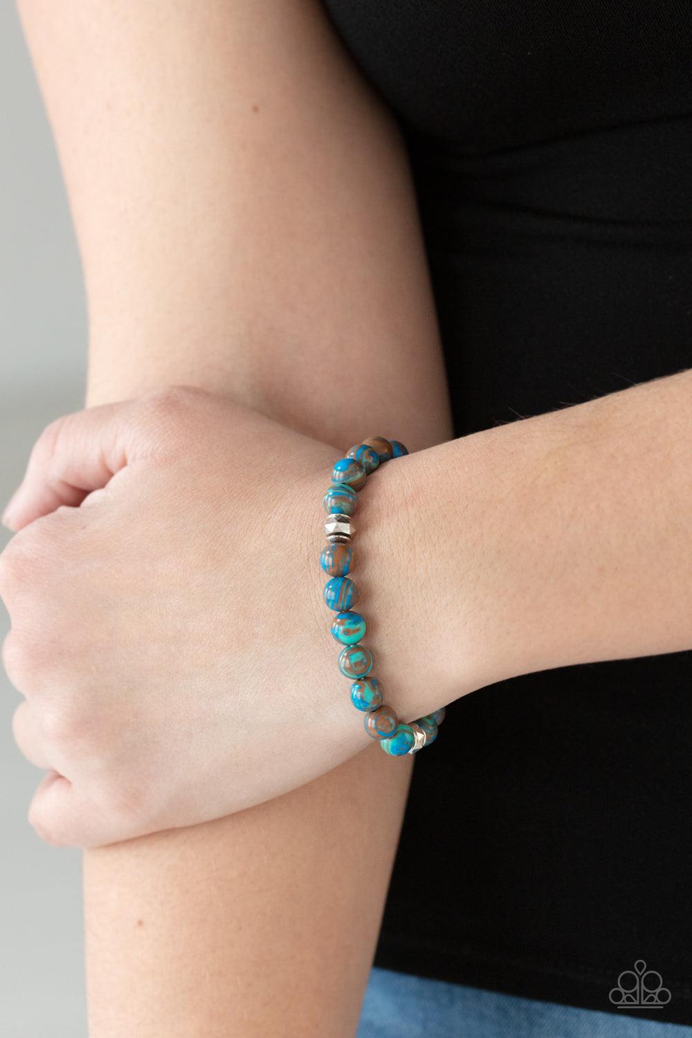 Paparazzi Accessories Awakened - Blue Swirling with blue, green, and brown details, earthy beads and faceted silver accents are threaded along a stretchy band around the wrist for a tranquil look. Sold as one individual bracelet. Jewelry