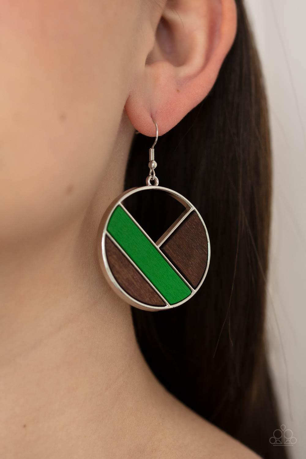 Paparazzi Accessories Dont Be MODest - Green Featuring green and brown finishes, geometric wooden frames piece together inside an airy silver hoop for a modern look. Earring attaches to a standard fishhook fitting. Sold as one pair of earrings. Earrings