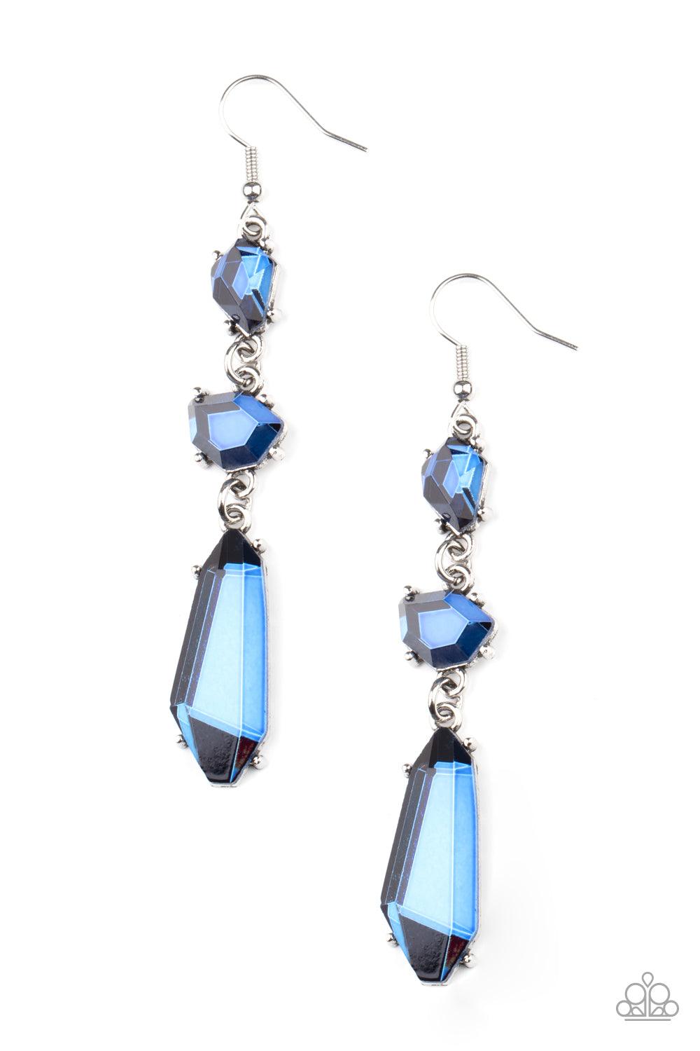 Paparazzi Accessories Sophisticated Smolder - Blue Featuring raw cuts, an asymmetrical collection of faceted blue gems trickles from the ear, creating a smoldering chandelier. Earring attaches to a standard fishhook fitting. Sold as one pair of earrings.
