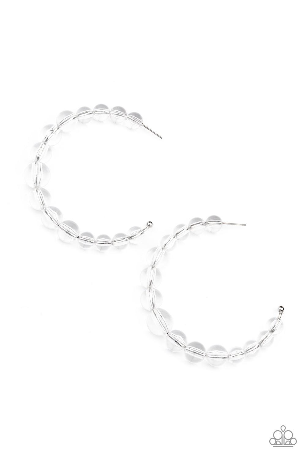 Paparazzi Accessories In The Clear - White Gradually increasing in size at the center, a glassy collection of white beads are threaded along an oversized hoop for a bubbly effect. Earring attaches to a standard post fitting. Hoop measure approximately 2 1