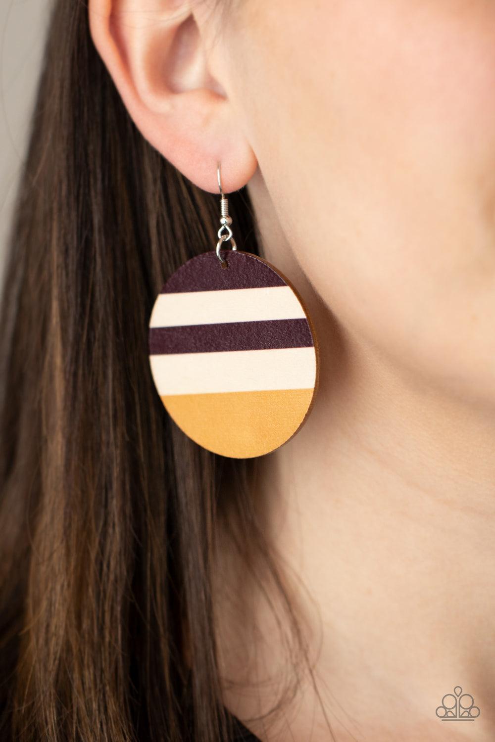 Paparazzi Accessories Yacht Party - Yellow The front of a shiny wooden disc is stripped in purplish-brown and yellow accents, creating a colorful summery look. Earring attaches to a standard fishhook fitting. Sold as one pair of earrings. Jewelry