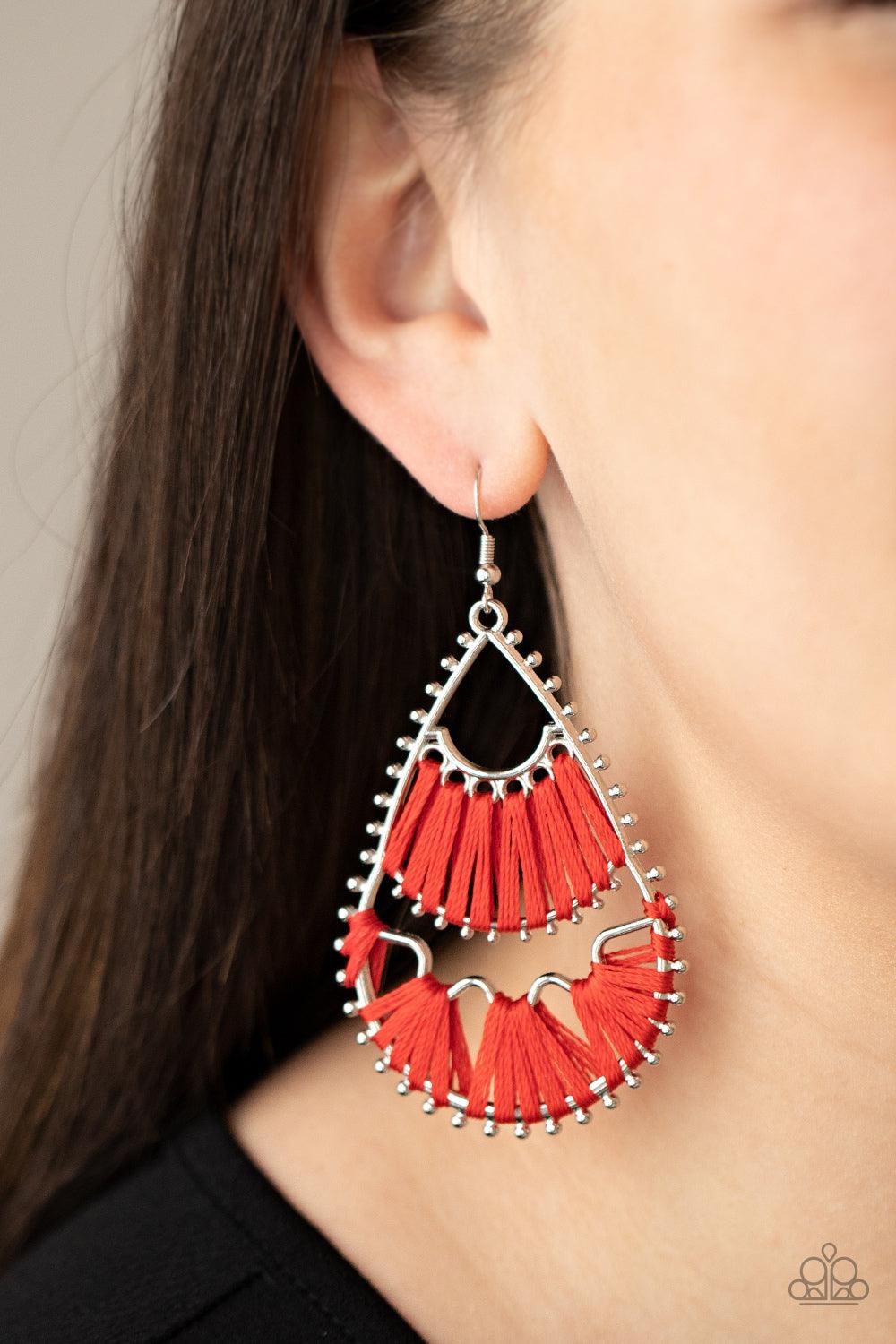 Paparazzi Accessories Samba Scene - Red Three abstract silver fittings section off the inside of a pronged teardrop. Red thread is wrapped around the bar-like fittings, creating colorful loom-like accents. Earring attaches to a standard fishhook fitting.