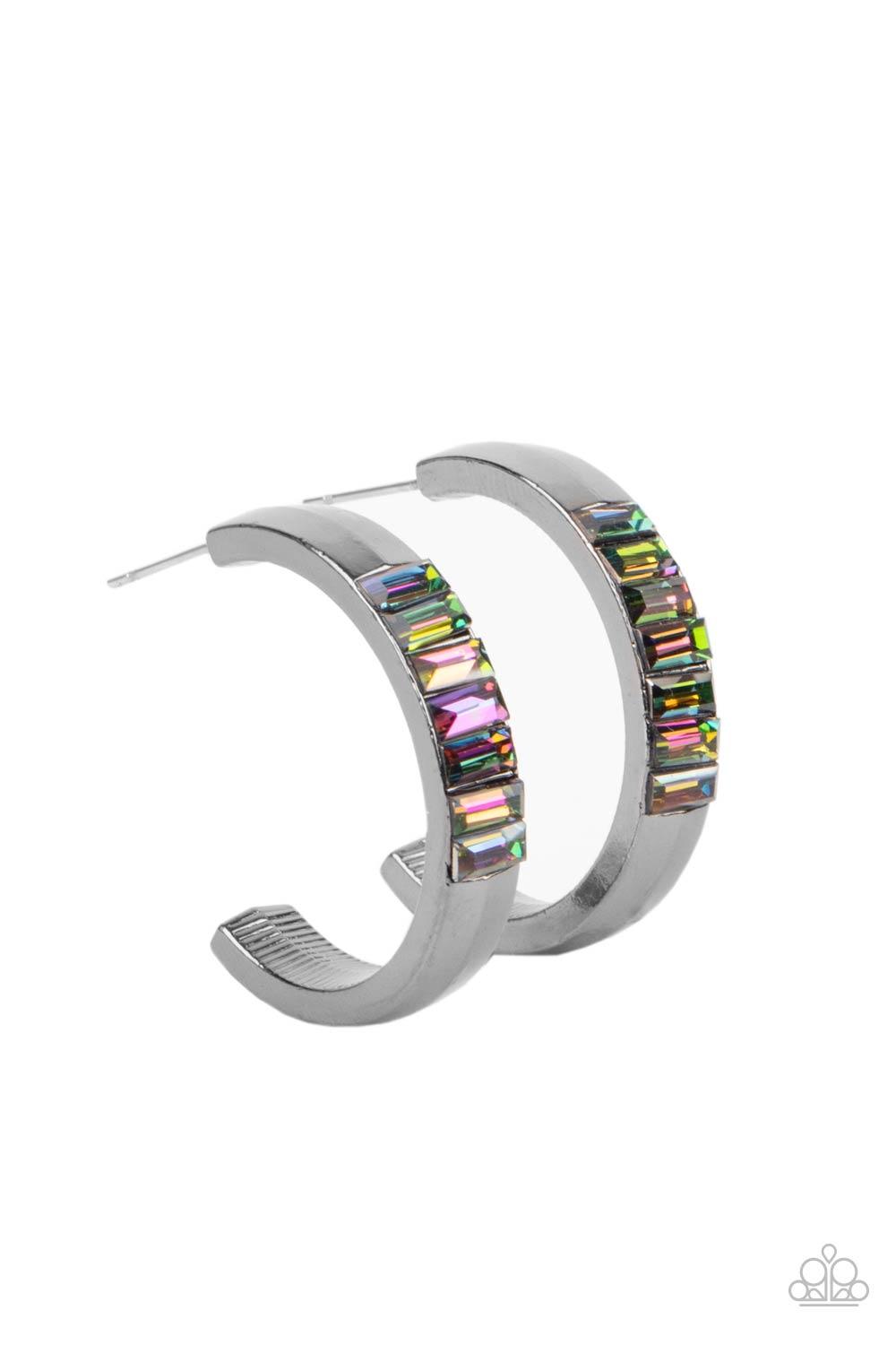 Paparazzi Accessories Bursting With Brilliance - Multi The front of a thick gunmetal hoop is encrusted in oil spill emerald cut rhinestones, creating a glamorous pop of color. Earring attaches to a standard post fitting. Hoop measures approximately 1" in