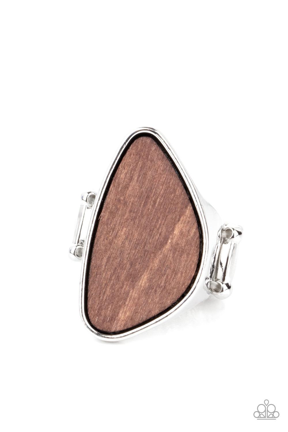 Paparazzi Accessories Perfectly Petrified - Brown An asymmetrical piece of rustic wood is nestled inside a sleek silver frame that thickens into a shimmery band around the finger, creating a refined centerpiece. Features a stretchy band for a flexible fit