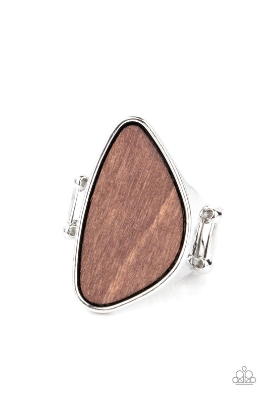 Paparazzi Accessories Perfectly Petrified - Brown An asymmetrical piece of rustic wood is nestled inside a sleek silver frame that thickens into a shimmery band around the finger, creating a refined centerpiece. Features a stretchy band for a flexible fit