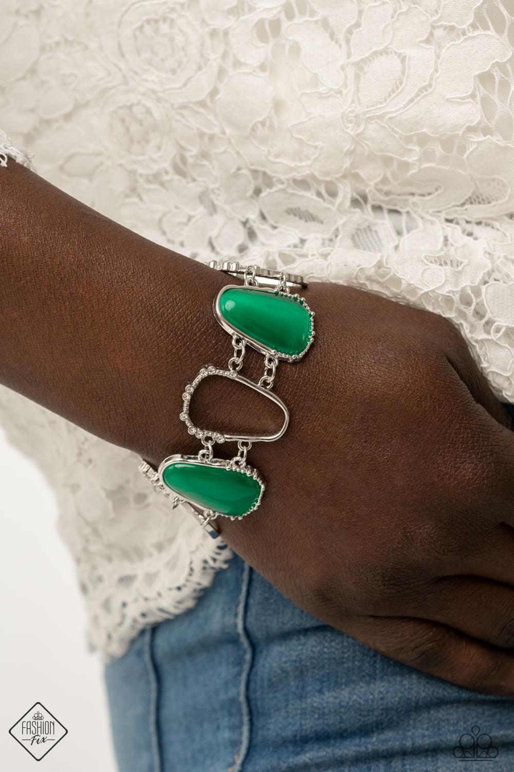 Paparazzi Accessories Yacht Club Couture - Green Encased in studded silver frames, a tranquil collection of asymmetrical Mint cat’s eye stone teardrops and airy silver frames delicately link around the wrist for an ethereally sparkly display. A sprinkling