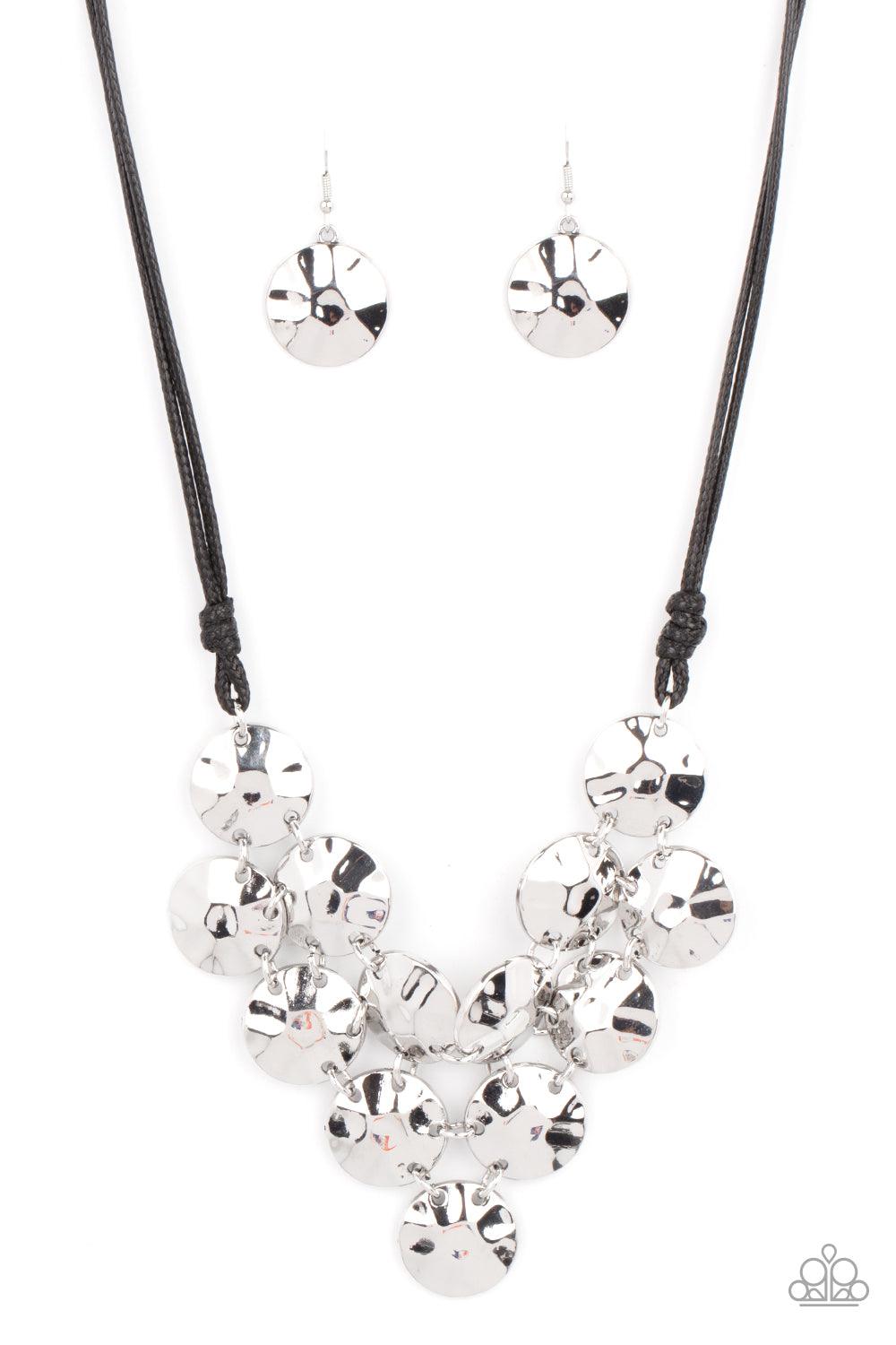 Paparazzi Accessories Token Treasure - Black Featuring a hammered finish, a collection of shiny silver discs delicately connect into a netted pendant at the bottom of knotted black cords for a statement-making look. Features an adjustable clasp closure. S