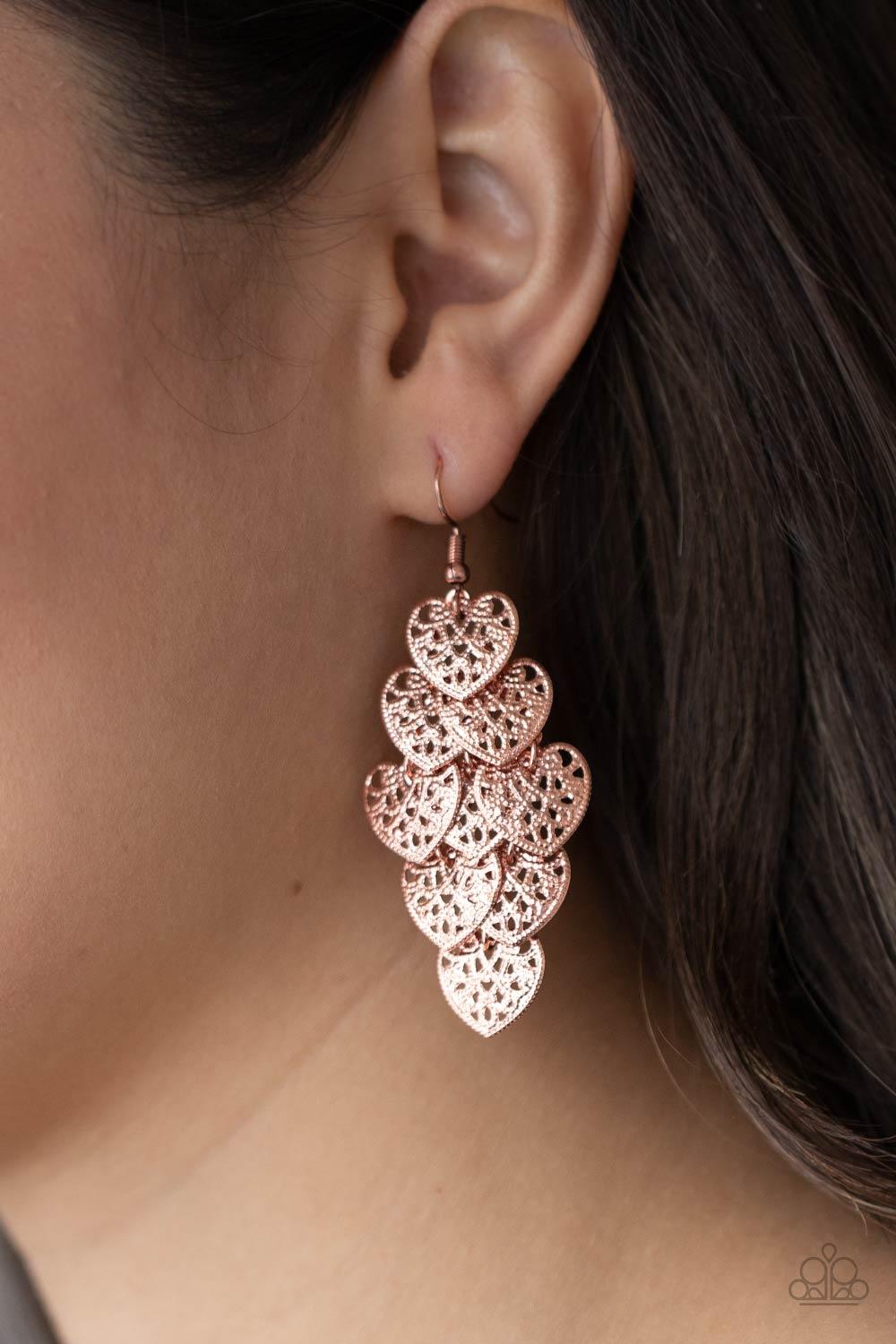 Paparazzi Accessories Shimmery Soulmates - Copper Featuring studded filigree filled centers, shiny copper heart frames cascade from the ear as they link into a flawless overlapping lure. Earring attaches to a standard fishhook fitting. Sold as one pair of