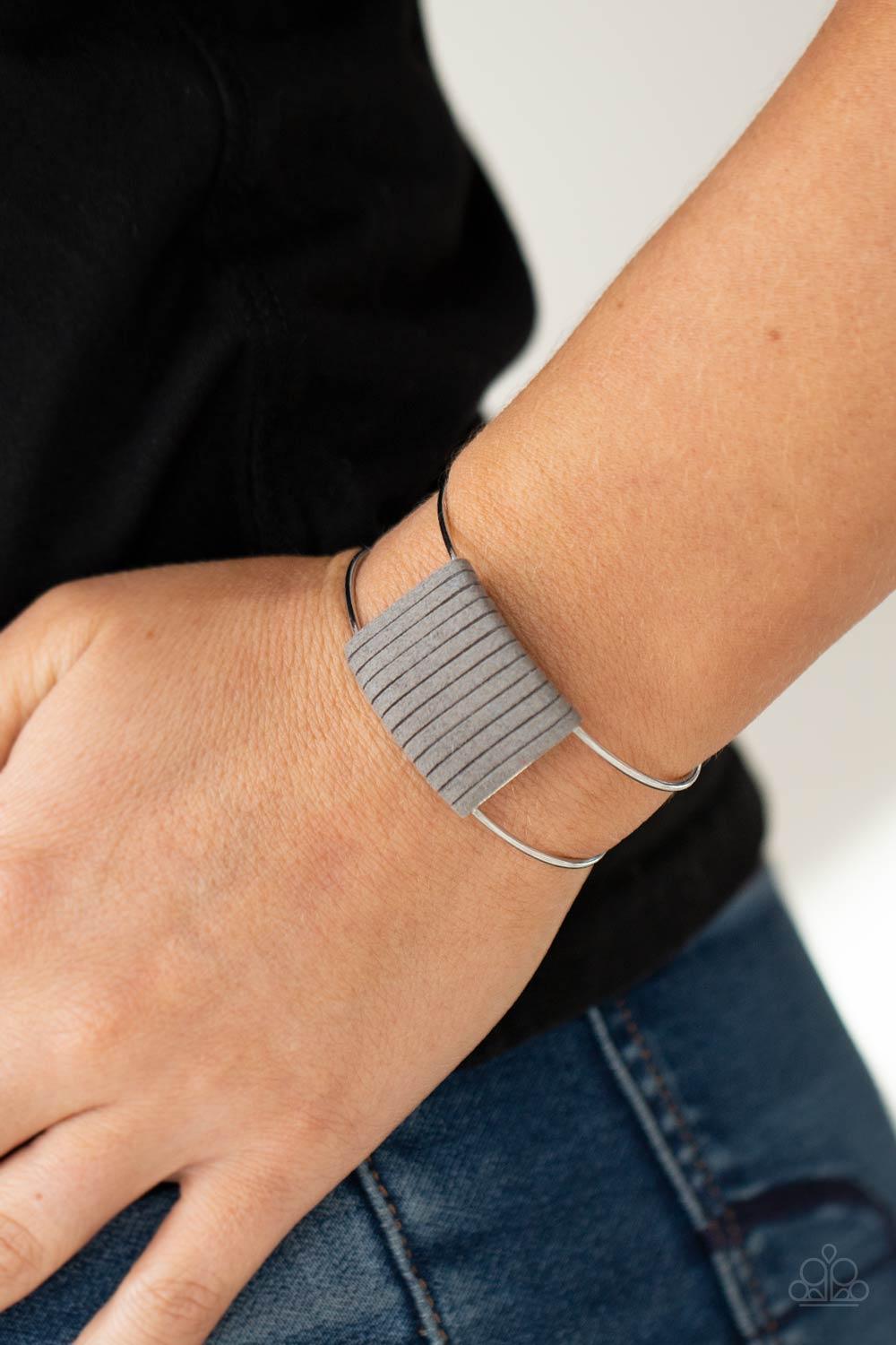 Paparazzi Accessories Free Expression - Silver Ultimate Gray suede cording wraps around a silver fitting nestled between an airy silver cuff, creating a colorfully rustic centerpiece. Sold as one individual bracelet. Jewelry