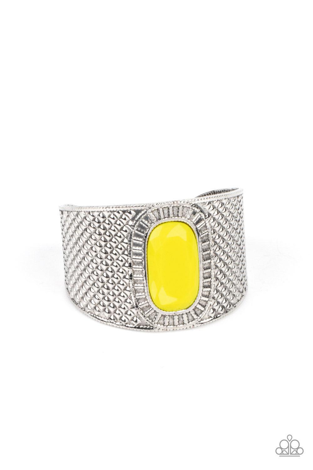 Paparazzi Accessories Poshly Pharaoh - Yellow An oversized faceted Illuminating bead is pressed into the center of a thick silver cuff that is embossed in diamond-like textures, creating a bold tribal inspired centerpiece around the wrist. Sold as one ind