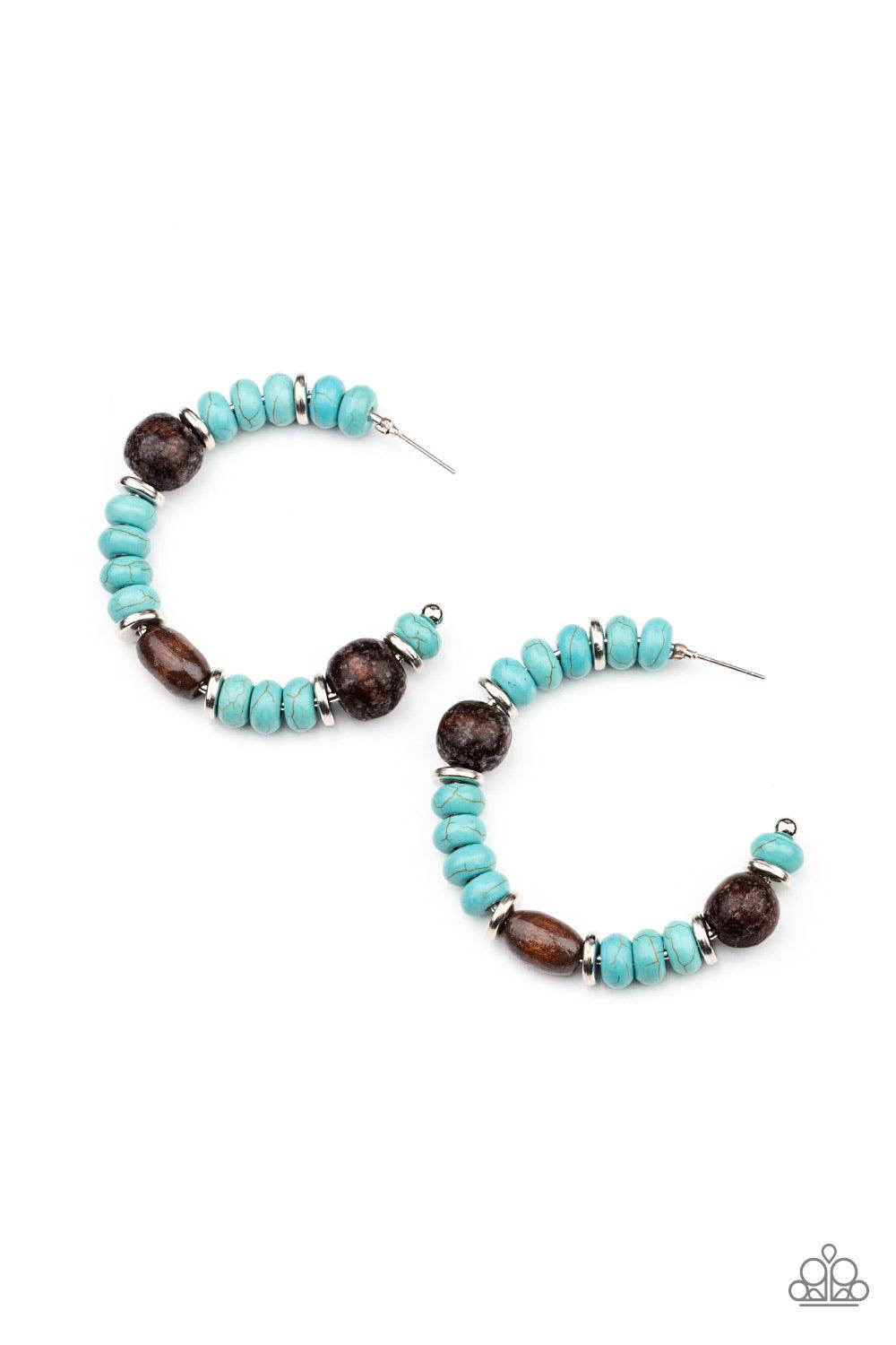 Paparazzi Accessories Definitely Down-To-Earth - Blue An earthy collection of turquoise stone beads, silver discs, and brown wooden beads are delicately threaded along a dainty wire, creating an artisan inspired hoop. Earring attaches to a standard post f