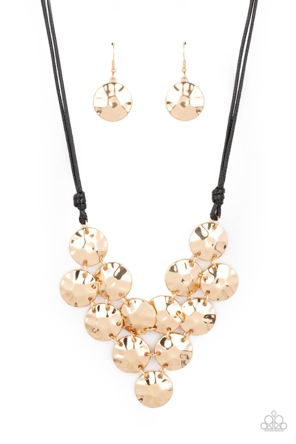 Paparazzi Accessories Token Treasure - Gold Featuring a hammered finish, a collection of glistening gold discs delicately connect into a netted pendant at the bottom of knotted black cords for a statement-making look. Features an adjustable clasp closure.