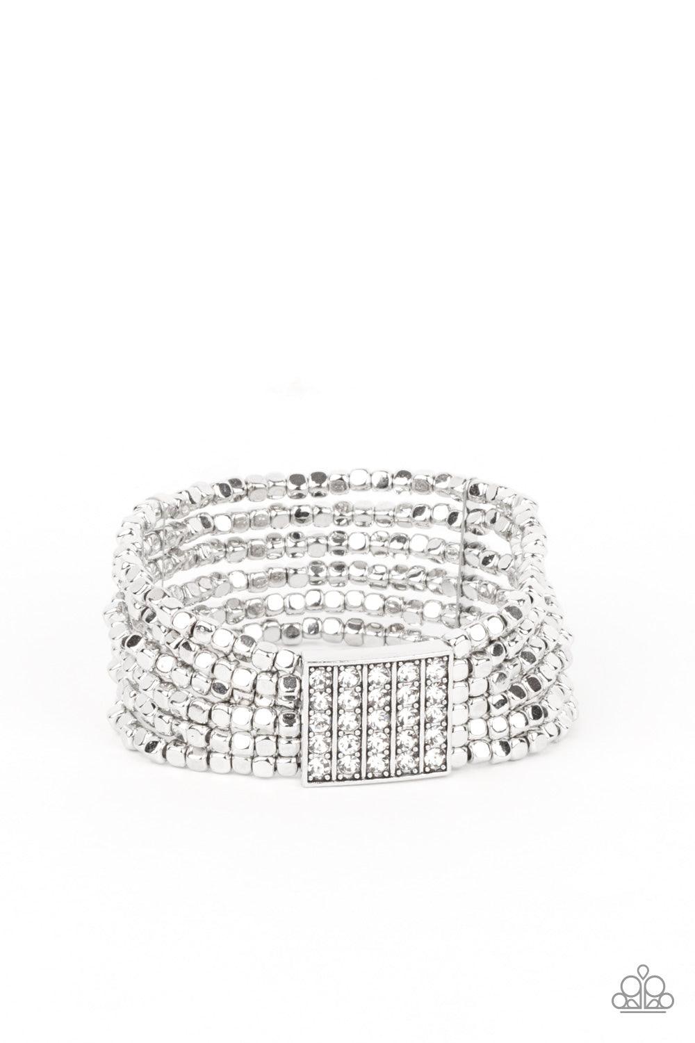 Paparazzi Accessories Star-Studded Showcase - White Held in place by a square centerpiece encrusted in row after row of dazzling rhinestones, a dainty collection of silver cube beads are threaded along stretchy bands around the wrist, creating shimmery la