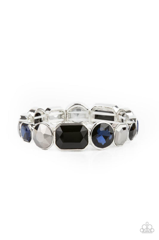 Paparazzi Accessories Extra Exposure - Multi Encased in sleek silver frames, a smoldering collection of round and emerald cut black, blue, and hematite rhinestones glide along stretchy bands around the wrist, creating a sparkly industrial statement piece.