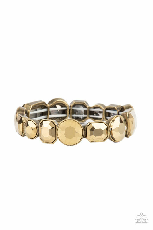 Paparazzi Accessories Extra Exposure - Brass Encased in sleek brass frames, a smoldering collection of round and emerald cut aurum rhinestones glide along stretchy bands around the wrist, creating a sparkly industrial statement piece. Sold as one individu
