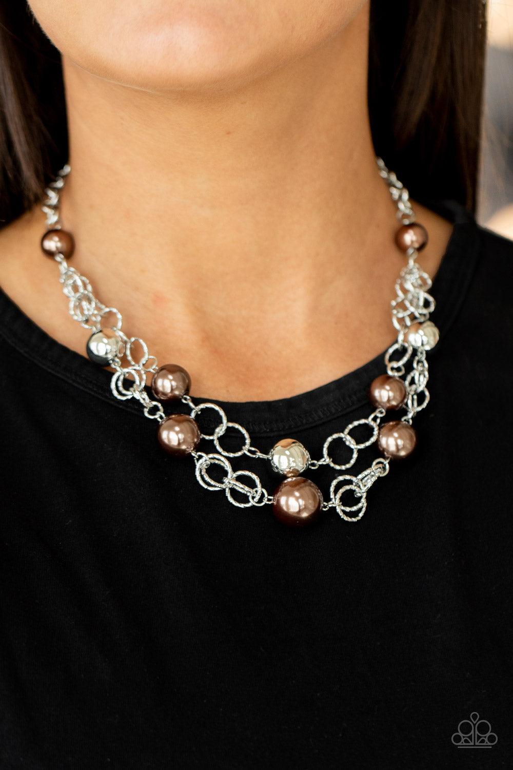 Paparazzi Accessories New Age Knockout - Brown Sections of oversized textured silver links, brown pearls, and shiny silver beads haphazardly connect into two timeless layers below the collar, creating a dramatically refined display. Features an adjustable