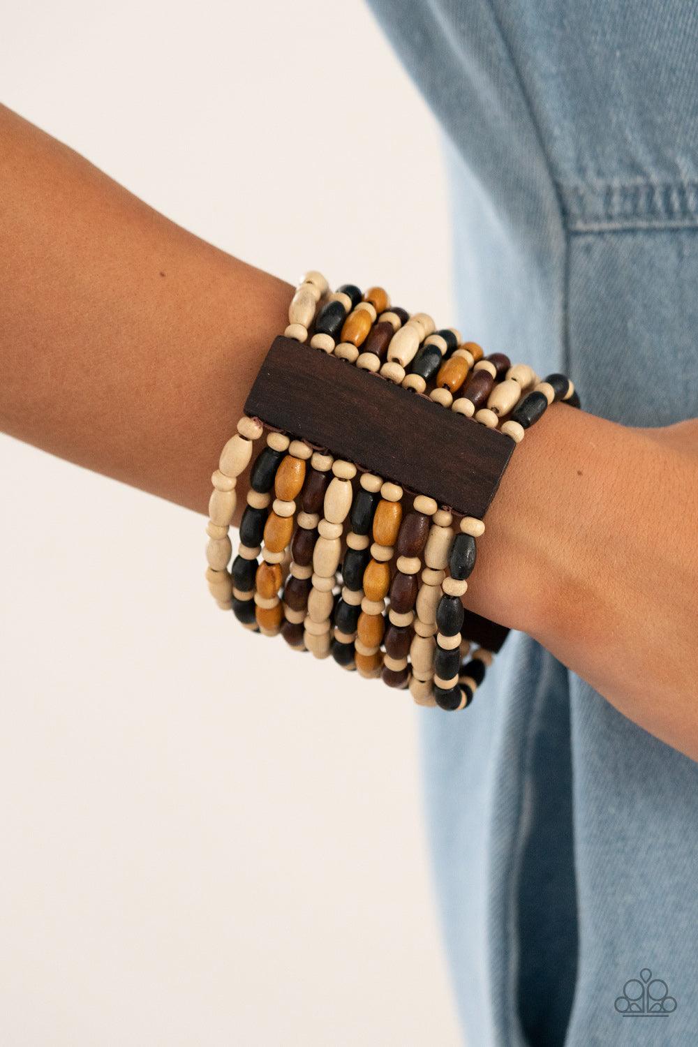 Paparazzi Accessories Cayman Carnival - Multi Held together with rectangular wooden frames, an earthy collection of white wooden beads and black, brown, and tan oval wooden beads are threaded along stretchy bands around the wrist for a bold beach inspired