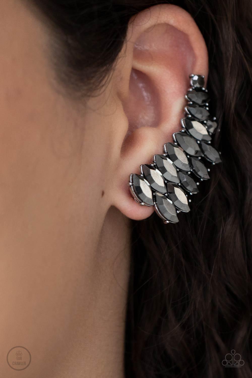 Paparazzi Accessories Explosive Elegance - Silver An explosion of marquise-cut hematite rhinestones delicately climb the ear, coalescing into a smoldering frame. Earring attaches to a standard post fitting. Features a clip-on fitting at the top for a secu