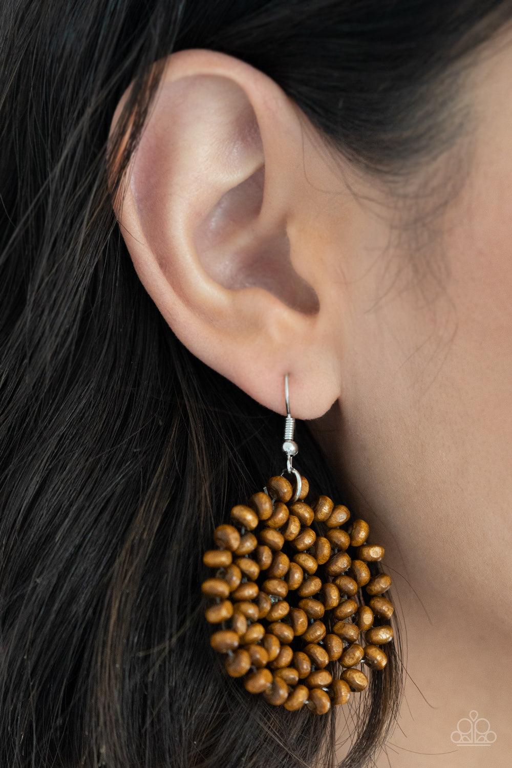Paparazzi Accessories Summer Escapade - Brown Clusters of dainty brown wooden beads are threaded along invisible wires, creating a vivacious floral pattern frame for a summery flair. Earring attaches to a standard fishhook fitting. Sold as one pair of ear