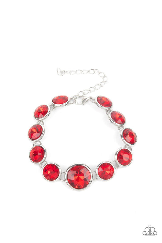 Paparazzi Accessories Lustrous Luminosity - Red Featuring sleek silver fittings, an oversized collection of fiery red gems delicately link around the wrist. The centermost gem is slightly larger than the rest, adding a glamorous finish. Features an adjust