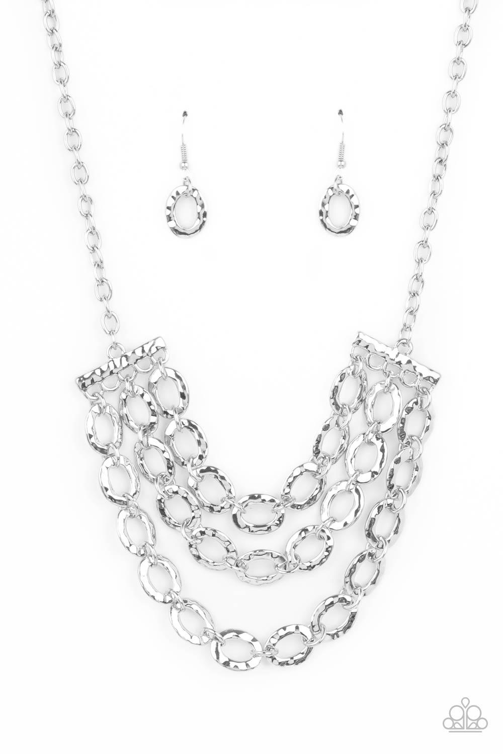 Paparazzi Accessories Repeat After Me - Silver Three rows of shiny silver chains with oversized hammered oval links attach to silver bars for an edgy display below the collar. Features an adjustable clasp closure. Sold as one individual necklace. Includes