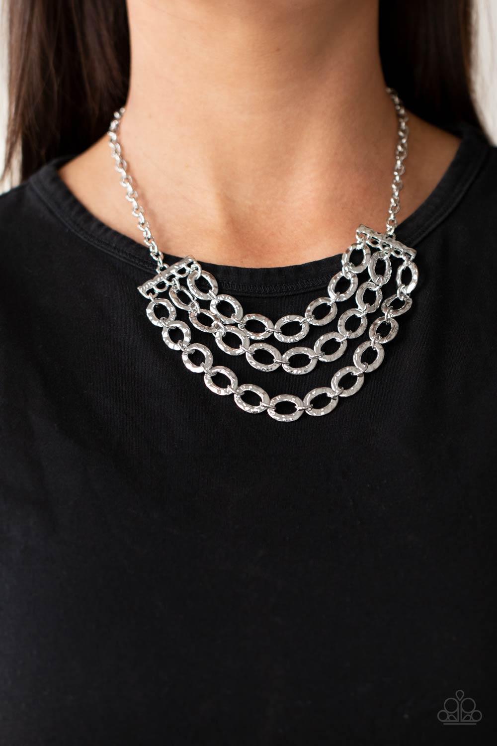 Paparazzi Accessories Repeat After Me - Silver Three rows of shiny silver chains with oversized hammered oval links attach to silver bars for an edgy display below the collar. Features an adjustable clasp closure. Sold as one individual necklace. Includes