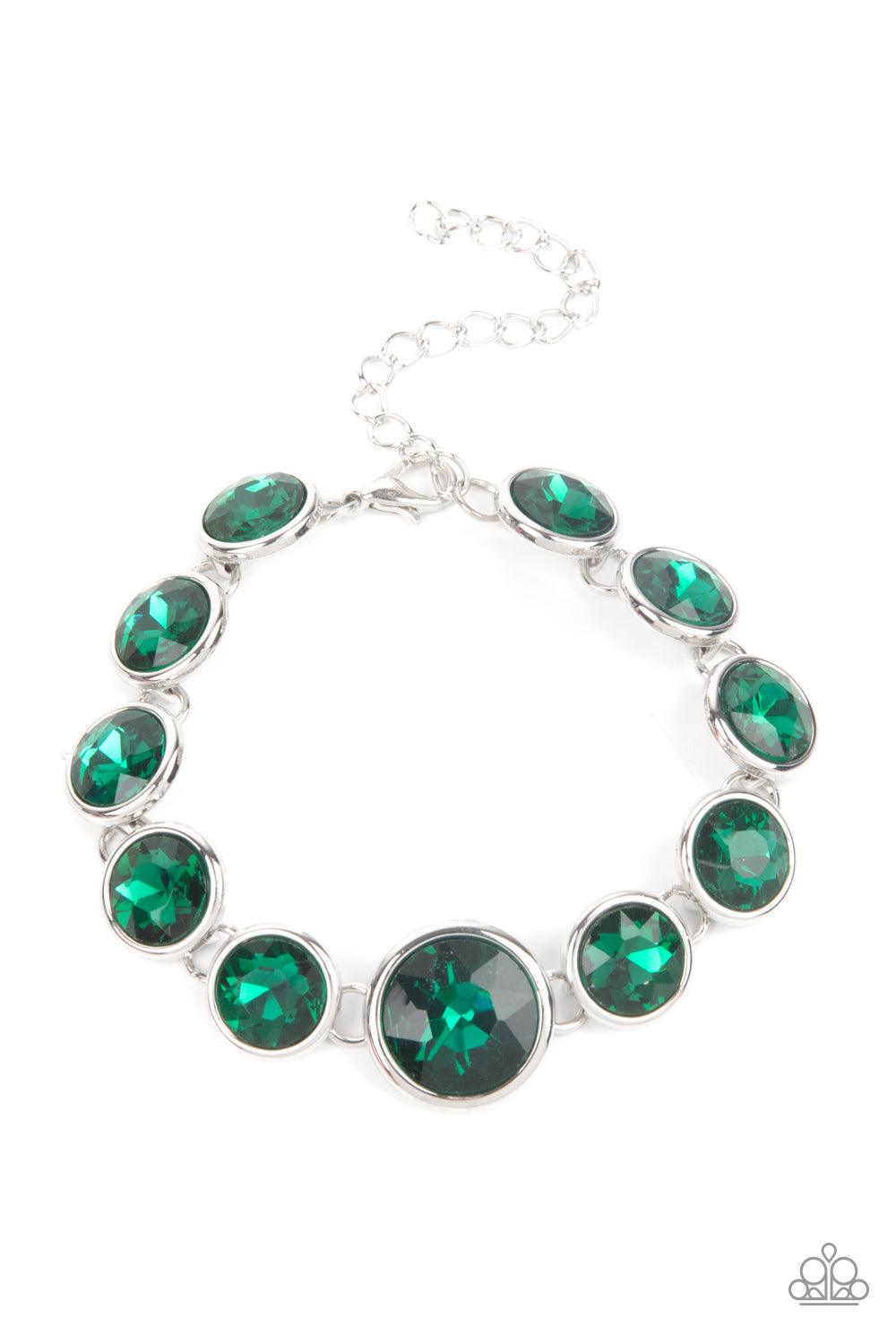 Paparazzi Accessories Lustrous Luminosity - Green Featuring sleek silver fittings, an oversized collection of sparkly green gems delicately link around the wrist. The centermost gem is slightly larger than the rest, adding a glamorous finish. Features an