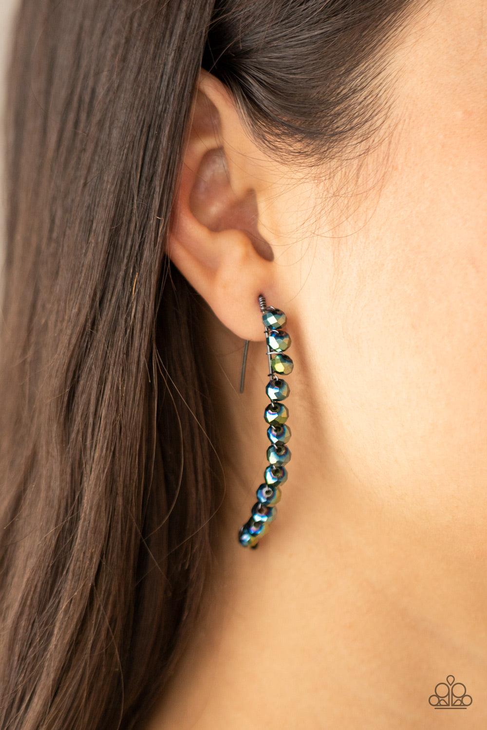 Paparazzi Accessories GLOW Hanging Fruit - Multi A glittery collection of iridescent flecked metallic blue rhinestones are fitted in place along a curved gunmetal wire, creating a glamorous hanging post. Earring attaches to a standard hanging post fitting