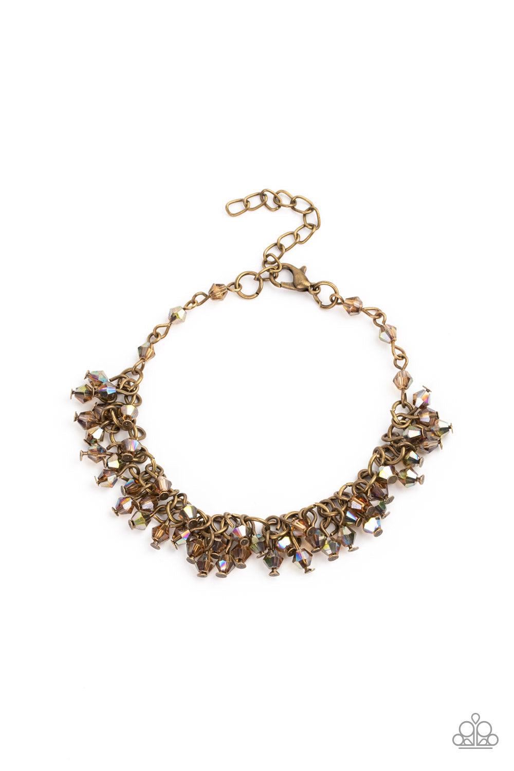 Paparazzi Accessories Twinkly Twilight - Brass Dainty brassy tone-on-tone iridescent beads swing from a classic brass chain, creating a clustered fringe around the wrist. Features an adjustable clasp closure. Sold as one individual bracelet. Get The Compl